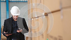 Factory manager using tablet computer in warehouse or factory