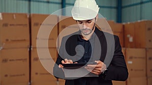 Factory manager using tablet computer in warehouse or factory