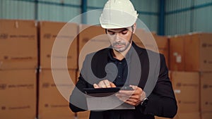 Factory manager using tablet computer in warehouse or factory