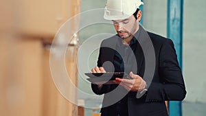 Factory manager using tablet computer in warehouse or factory