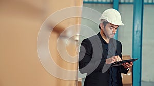 Factory manager using tablet computer in warehouse or factory