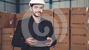 Factory manager using tablet computer in warehouse or factory