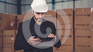 Factory manager using tablet computer in warehouse or factory