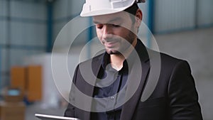 Factory manager using tablet computer in warehouse or factory