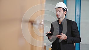 Factory manager using tablet computer in warehouse or factory