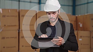 Factory manager using tablet computer in warehouse or factory