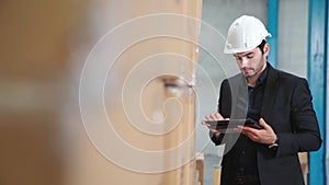 Factory manager using tablet computer in warehouse or factory