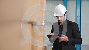 Factory manager using tablet computer in warehouse or factory