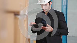 Factory manager using tablet computer in warehouse or factory