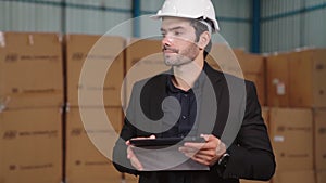 Factory manager using tablet computer in warehouse or factory