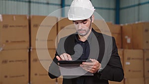 Factory manager using tablet computer in warehouse or factory