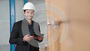 Factory manager using tablet computer in warehouse or factory