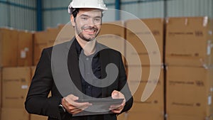 Factory manager using tablet computer in warehouse or factory