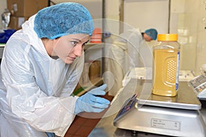 Factory operative weighing sample photo