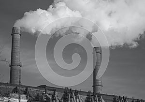 Factory pipe polluting air, smoke from chimneys against sun, environmental problems, ecological theme