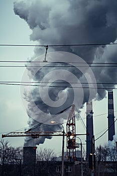 Factory pipe polluting air, smoke from chimneys, environmental problems, ecological theme, industry scene. Dramatic gray