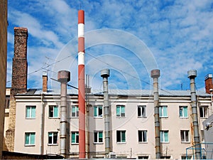 Factory pipes on a background of the house