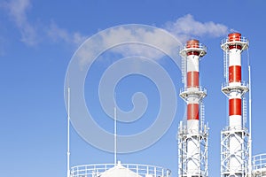 Factory plant smoke stack over blue sky background. Thermal condensing power plant. Energy generation and air environment pollutio