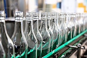 Factory for the production of alcoholic beverages. Bottles of vodka on the conveyor