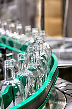 Factory for the production of alcoholic beverages. Bottles of vodka on the conveyor