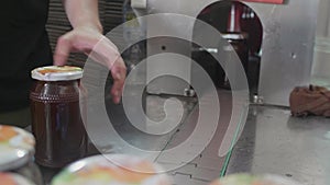 Factory production line with glass jars moving over conveer