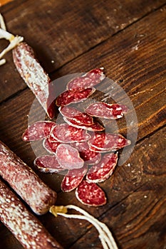 Factory for the production of meat products, boiled and smoked sausages. Traditional spicy sausage, ready to eat, lies sliced on a