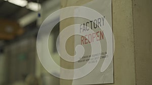 Factory Reopen sign inside the factory warehouse after shutting down affected by Coronavirus Covid-19.