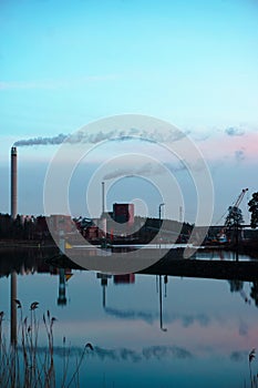 Factory on a river during evening