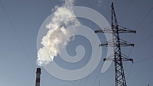 Factory smoke against the blue sky. Smoke pollution from industrial waste in the gas, chemical, oil and electrical