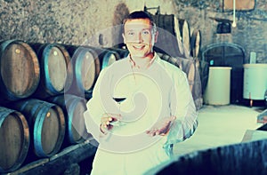 Factory sommelier checking quality of wine