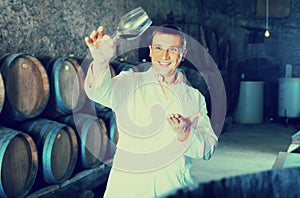 Factory sommelier checking quality of wine