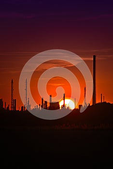 Factory on the sunset and the red sky. An industrial and production plant.