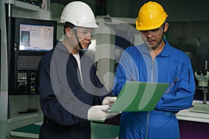 Factory technician, foreman and workers in technical discussion