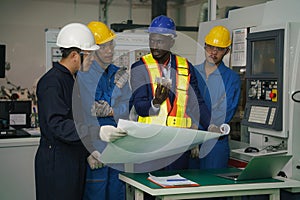 Factory technician, foreman and workers in technical discussion