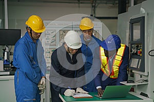 Factory technician, foreman and workers in technical discussion