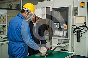 Factory technician, foreman and workers in technical discussion