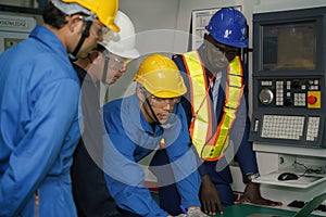 Factory technician, foreman and workers in technical discussion