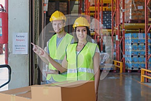 Factory warehouse workers with factory reopen notice at storehouse