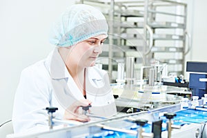 Factory woman worker operating production line