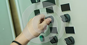 Factory worker adjusts the control panel of industry machine