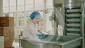 Factory worker checking packing machine. Candy factory.