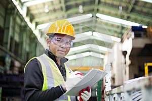 Factory worker with clipboard on the hand