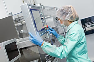 Factory worker configures control panel