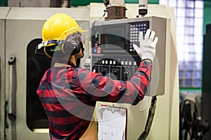 Factory worker control CNC lathe machine