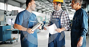 Factory worker discussing data with supervisor in metal factory