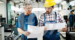 Factory worker discussing data with supervisor in metal factory