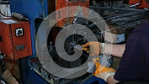 Factory Worker Drilling Metal Parts with a Machine