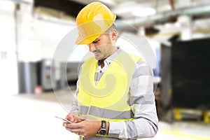 Factory worker employee chatting browsing texting on smartphone