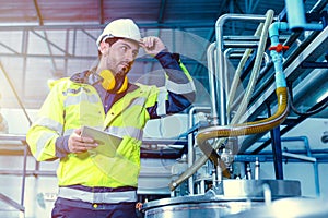 Factory worker Hispanic engineer working in factory checking maintenance pipe boiler system in factory