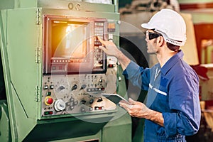 Factory worker man operate the machine, high skill labor work industry with safety clothes